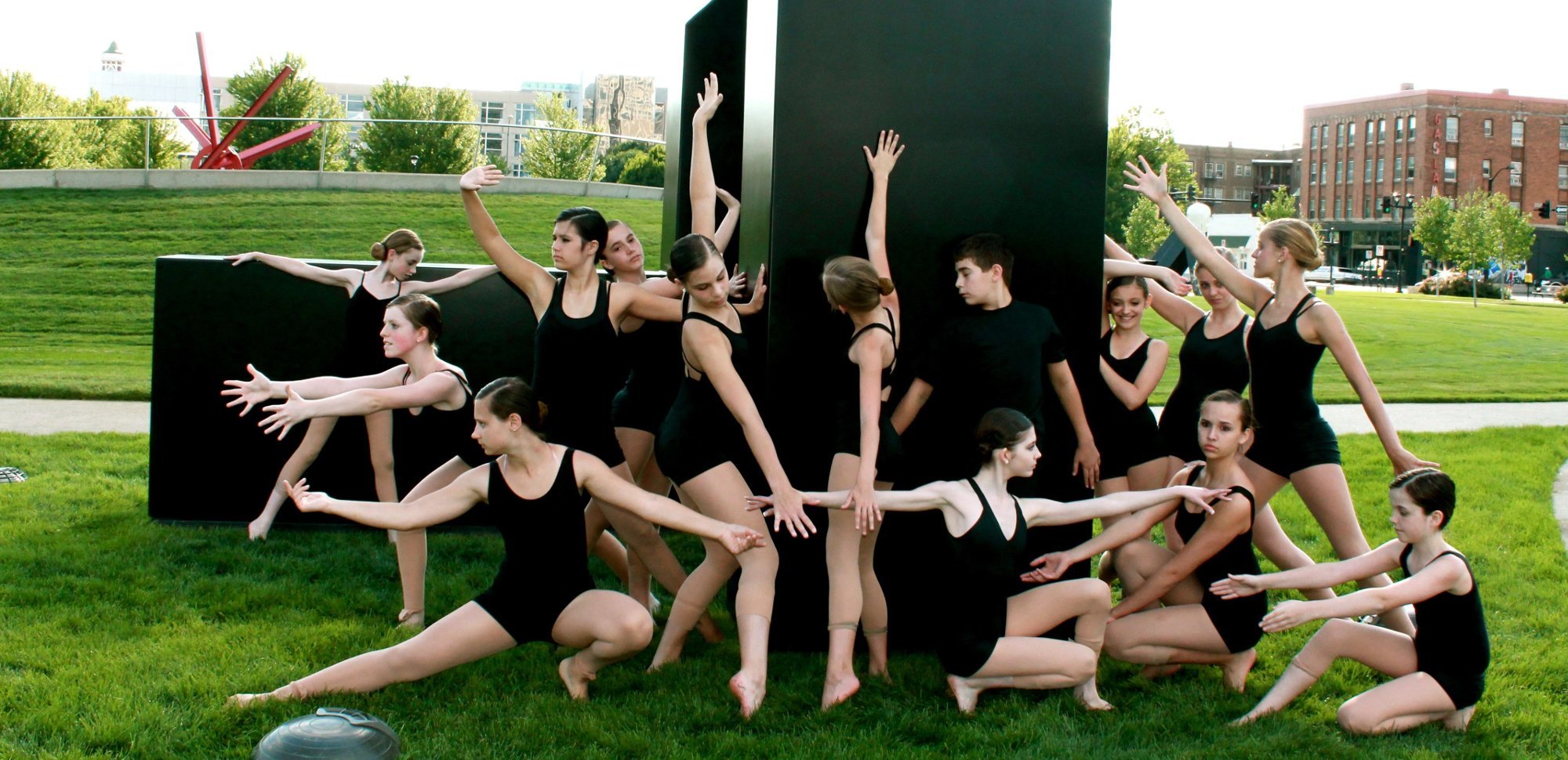 Brekke Dance Center students posing by a sculpture